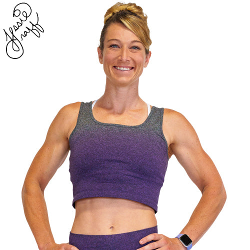 Photo of ninja warrior, Jessie Graff, wearing a purple ombre crop top. Her signature is in the top left of the photo
