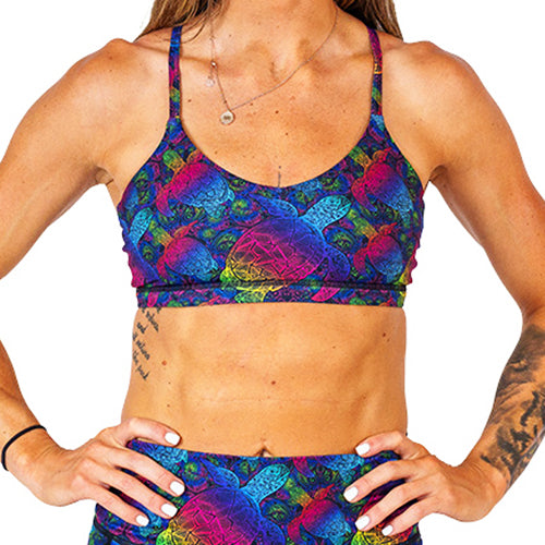 front view of rainbow colored turtle patterned sports bra