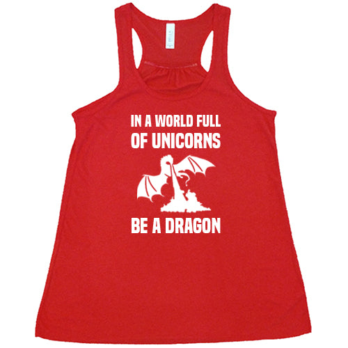 red racerback shirt with the saying "In A World Full Of Unicorns Be A Dragon" on it in white