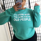 Spearmint colored crewneck with the saying "It's weird being the same age as old people"