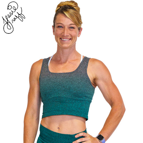 Photo of ninja warrior, Jessie Graff, wearing a teal ombre crop top. Her signature is in the top left of the photo