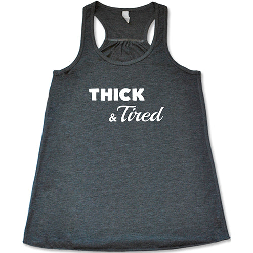 grey racerback shirt with the saying "thick & tired" in the center in white lettering