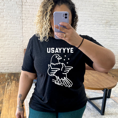 model wearing black unisex with saying "usayyye" and an eagle in white