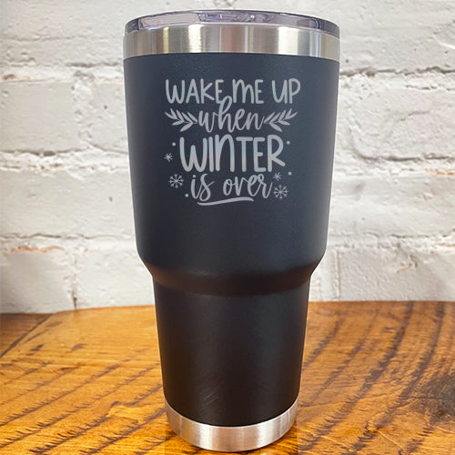 30oz black tumbler with silver saying "wake me up when winter is over" with mini snowflakes around it