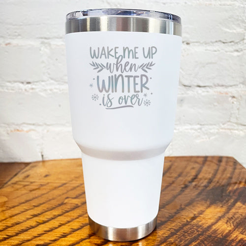 30oz white tumbler with silver saying "wake me up when winter is over" with mini snowflakes around it