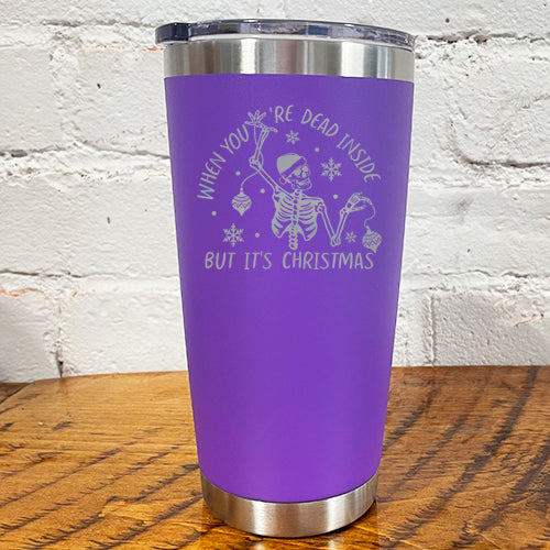  20oz purple tumbler with silver saying "when you're dead inside but it's christmas" with a santa hat skeleton holding ornaments