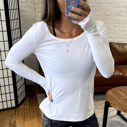 model taking a selfie of the white long sleeve shirt