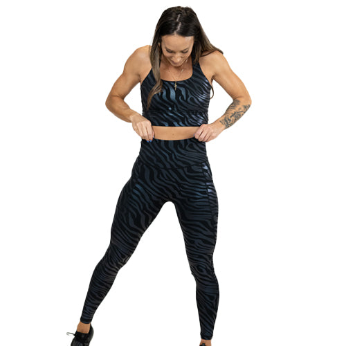 model wearing black zebra print full length leggings and matching sports bra